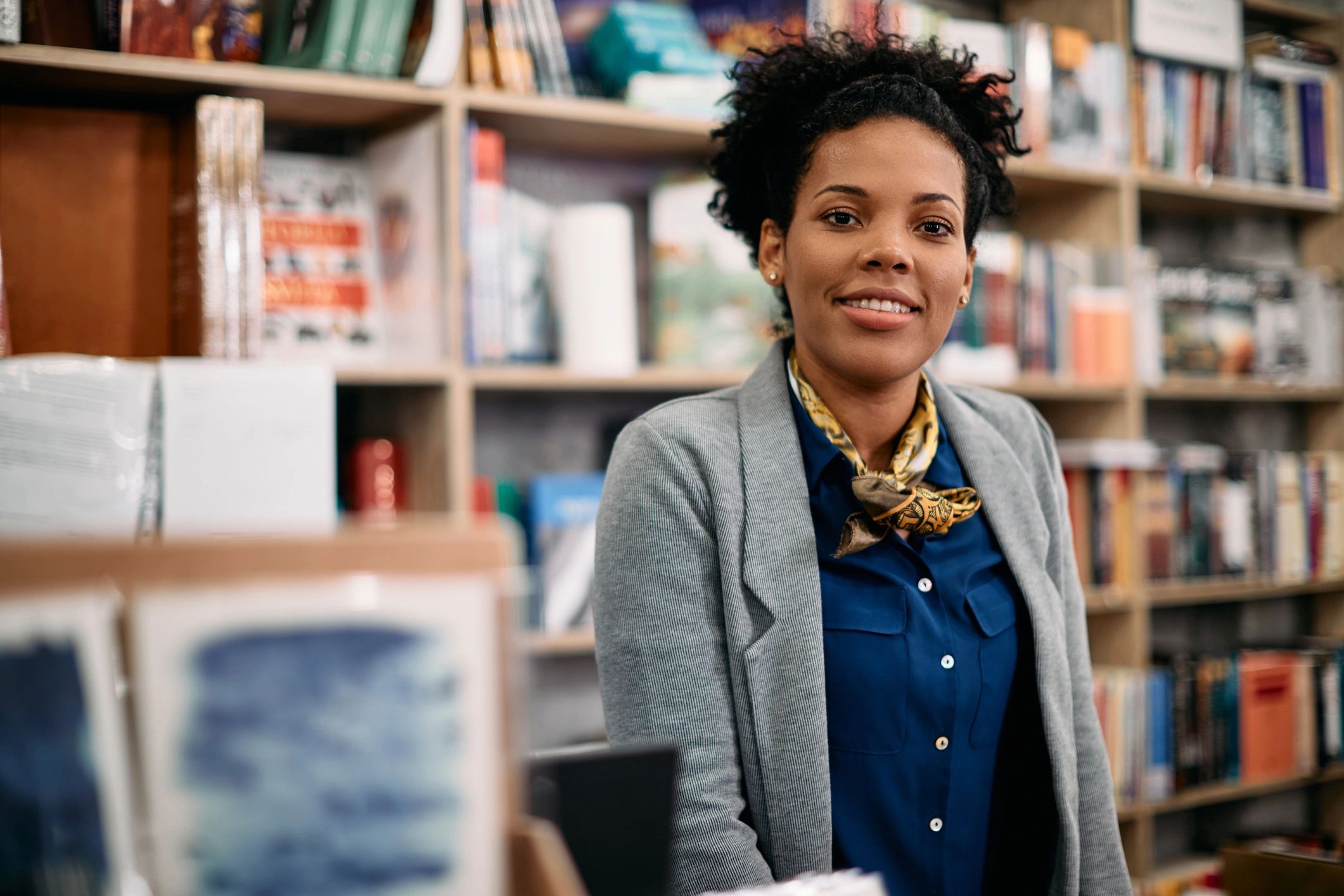 Young female customer reading a book in bookstore